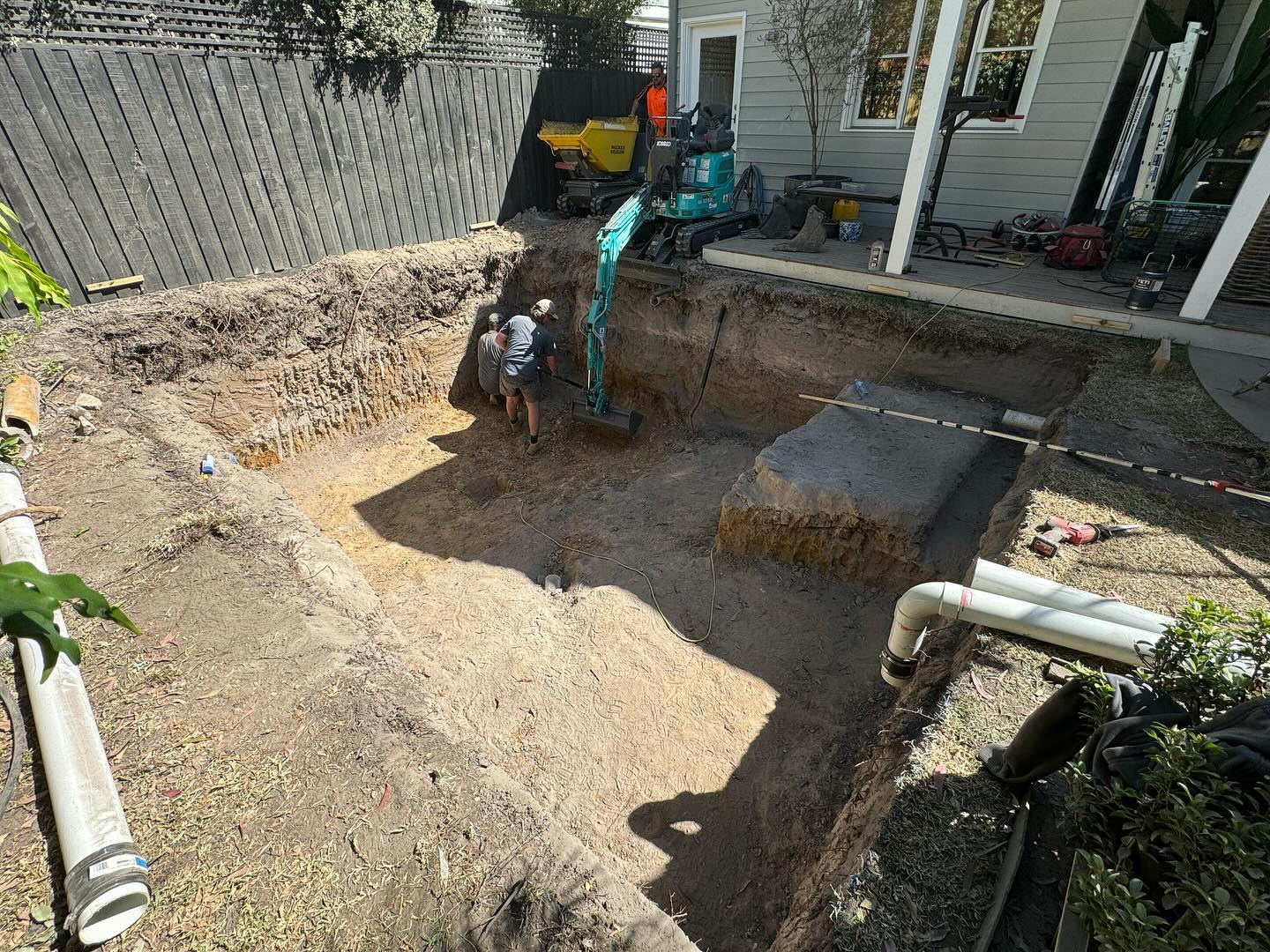 Construction workers digging home foundation.