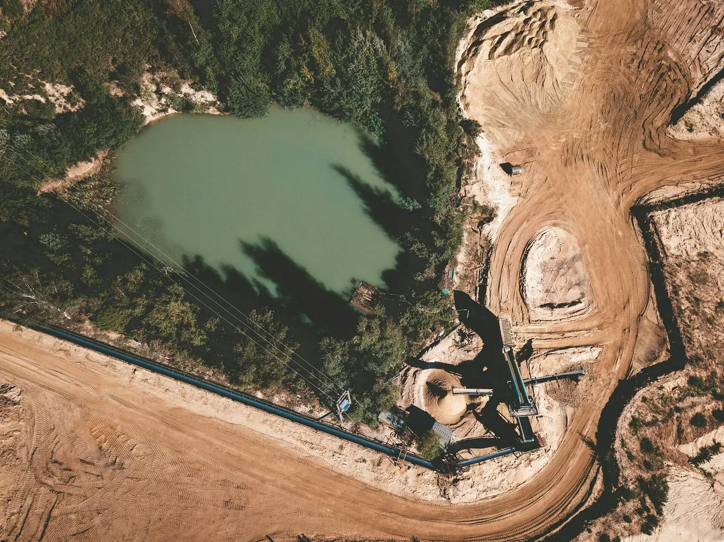 Aerial view of mining site and pond.